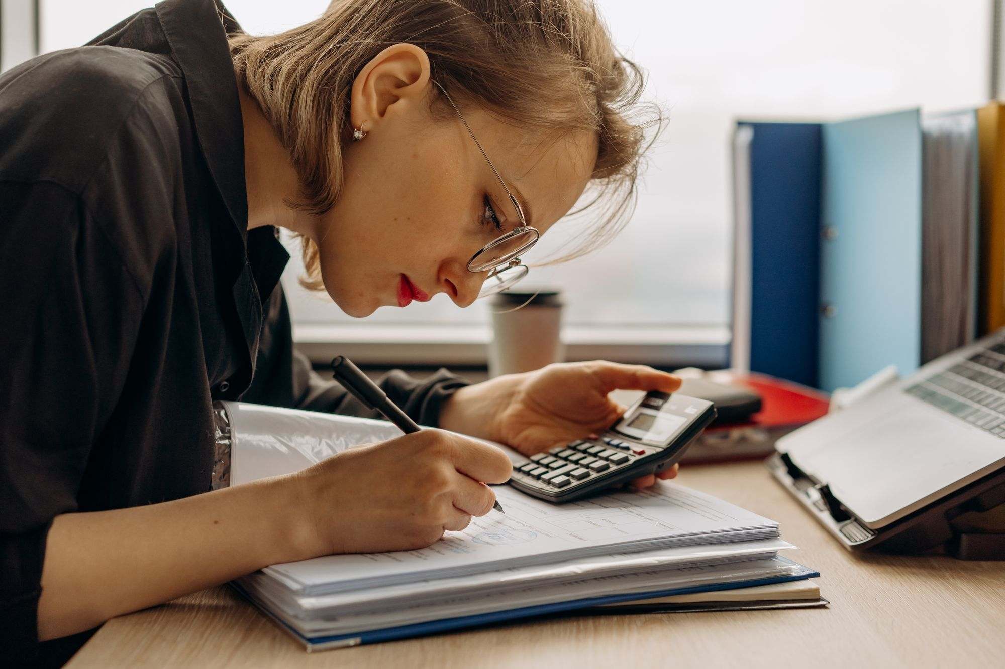 An accountant working through figures with a calculator