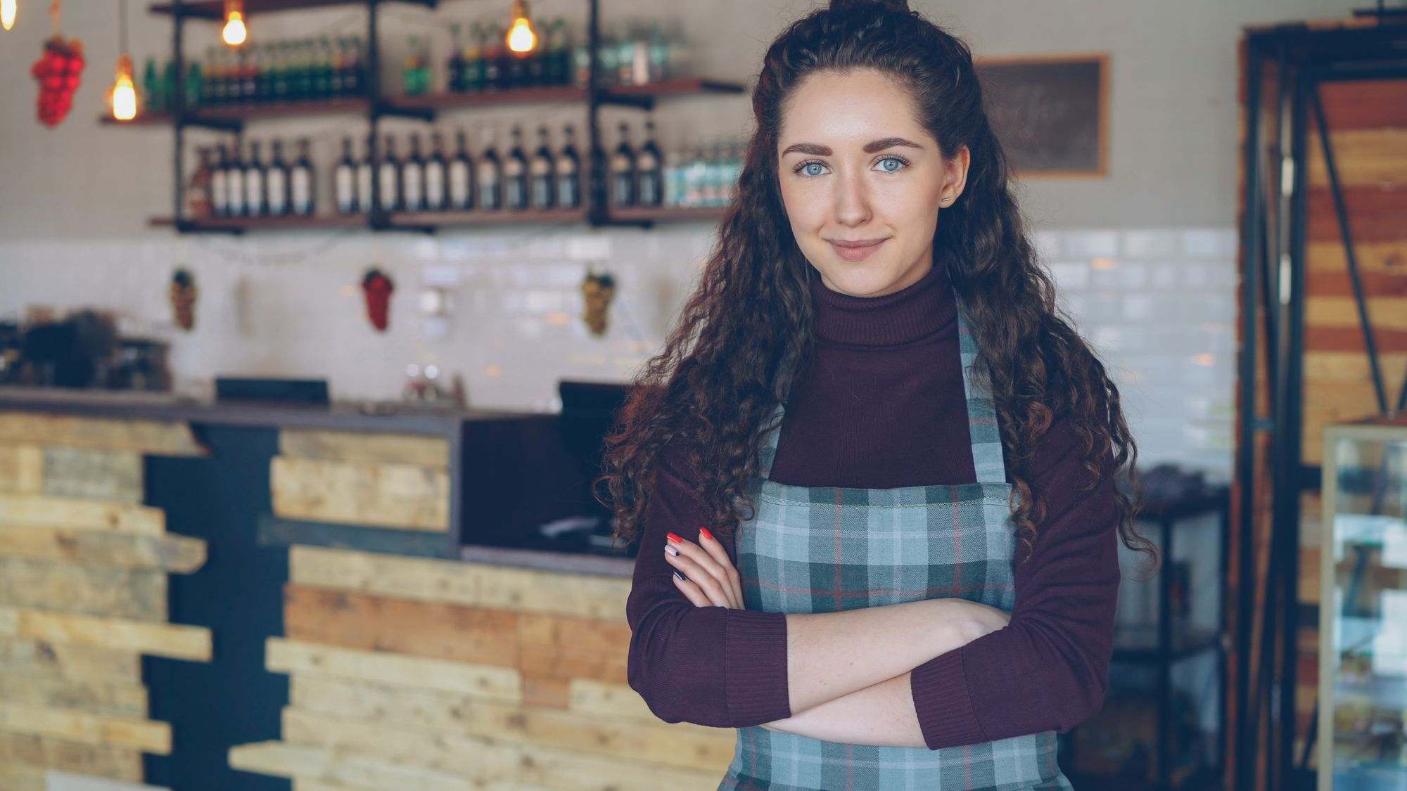 A café owner standing in a coffee shop