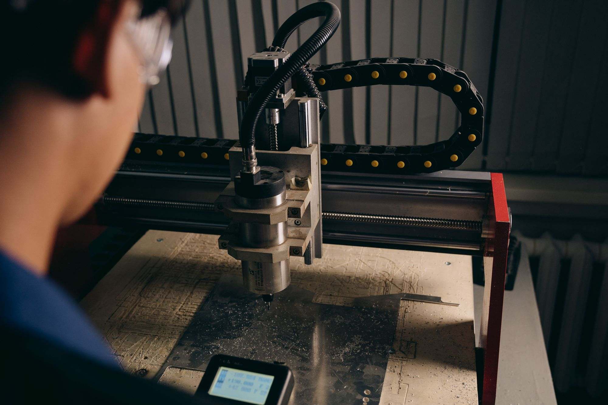 A CNC router cutting material in a workshop