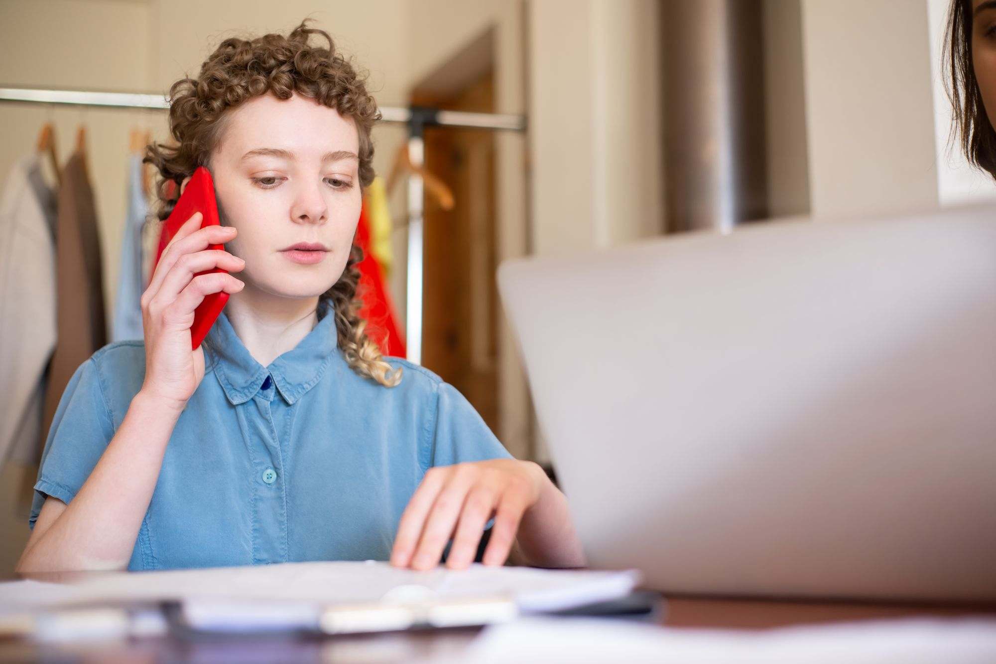 A small business owner on the phone at her desk