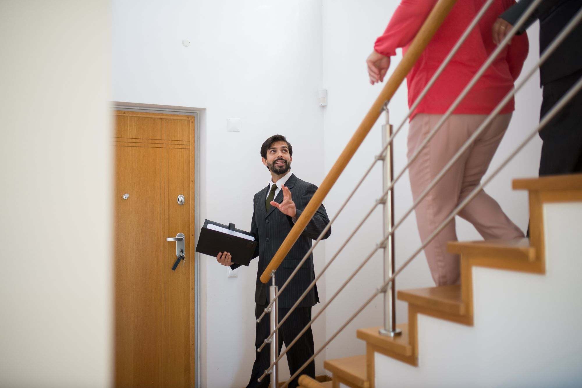 A real estate agent showing a buyer around a home
