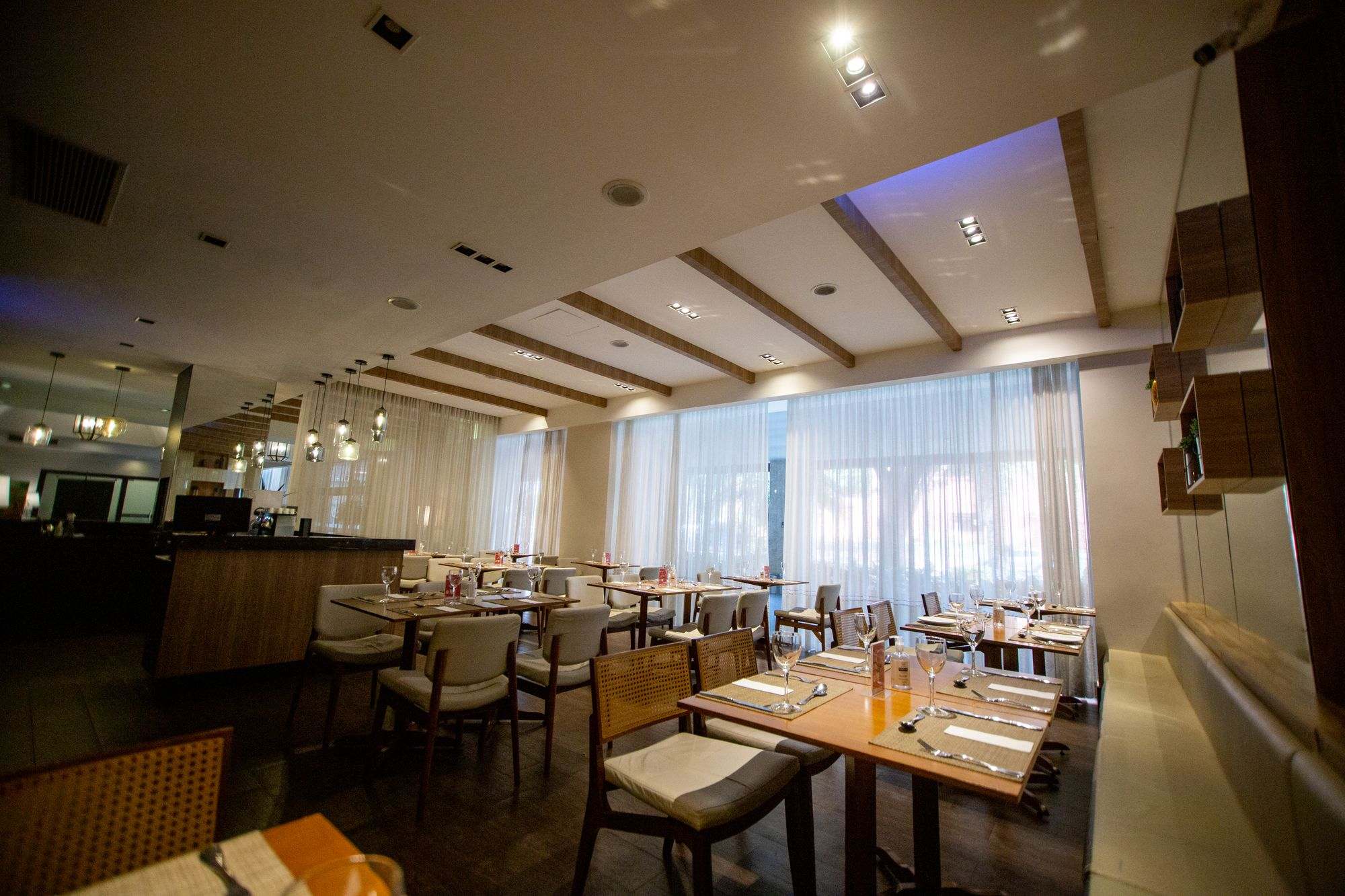 A restaurant dining room with set tables and warm lighting
