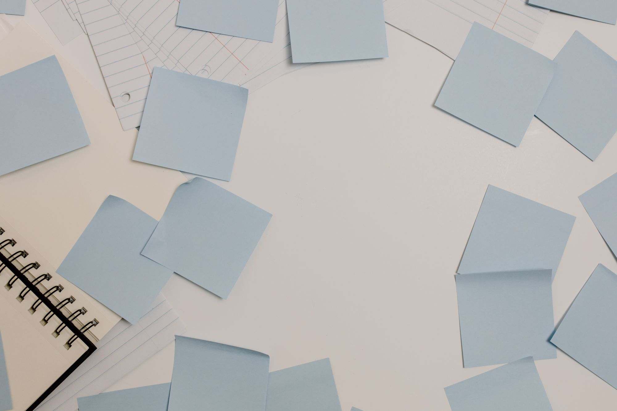 Sticky notes and a notepad spread across a desk
