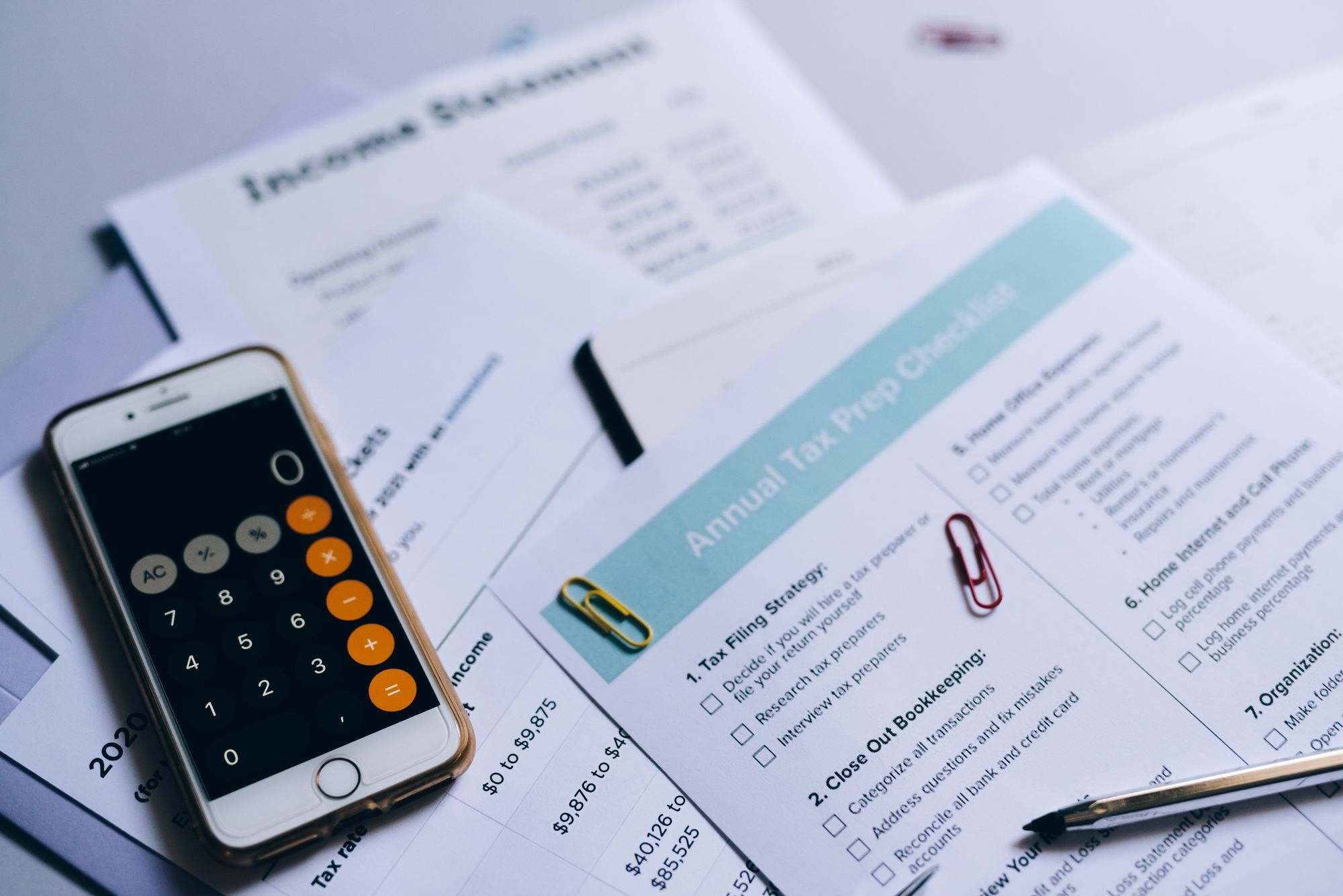 Tax preparation papers and a calculator on a desk
